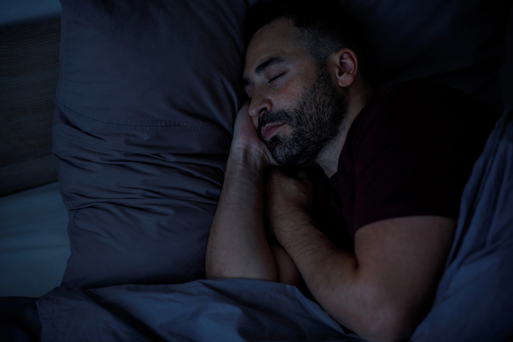 Man smiling and sleeping in bed